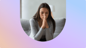 a woman sitting on a couch, looking concerned