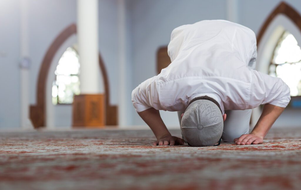Man praying in a mosque.