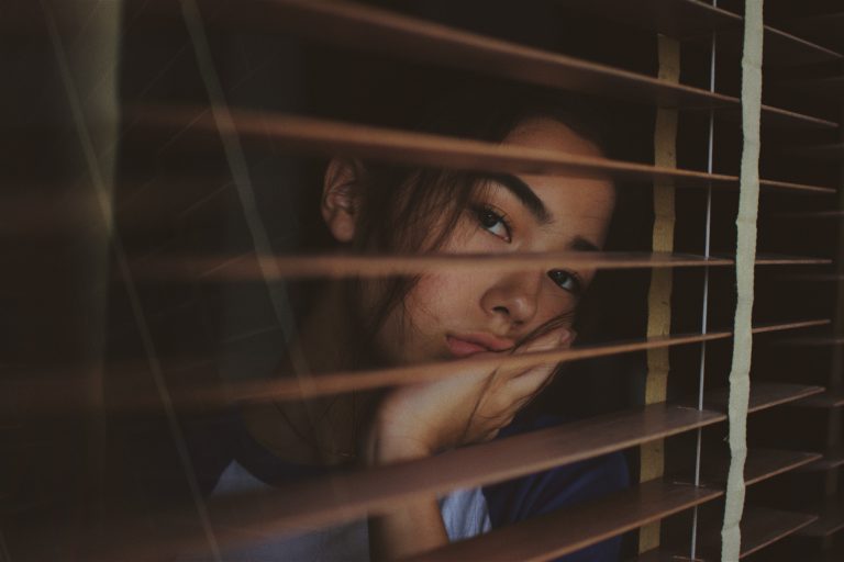 A obessed girl looking out of the window