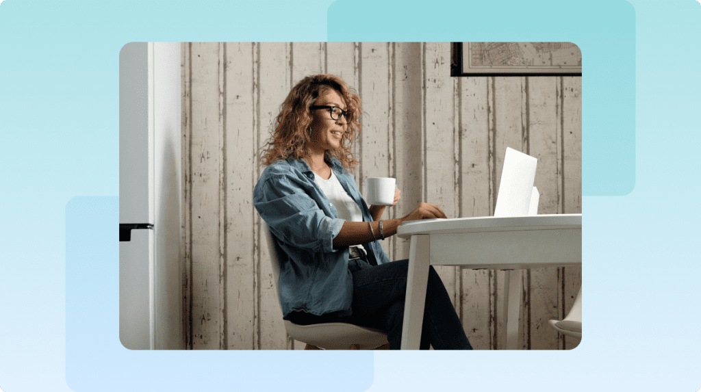 person sitting at a table with a laptop
