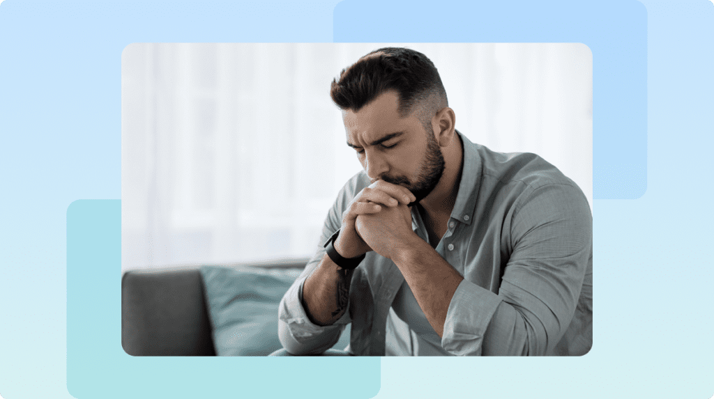 Person with eyes closed and hands touching their face.