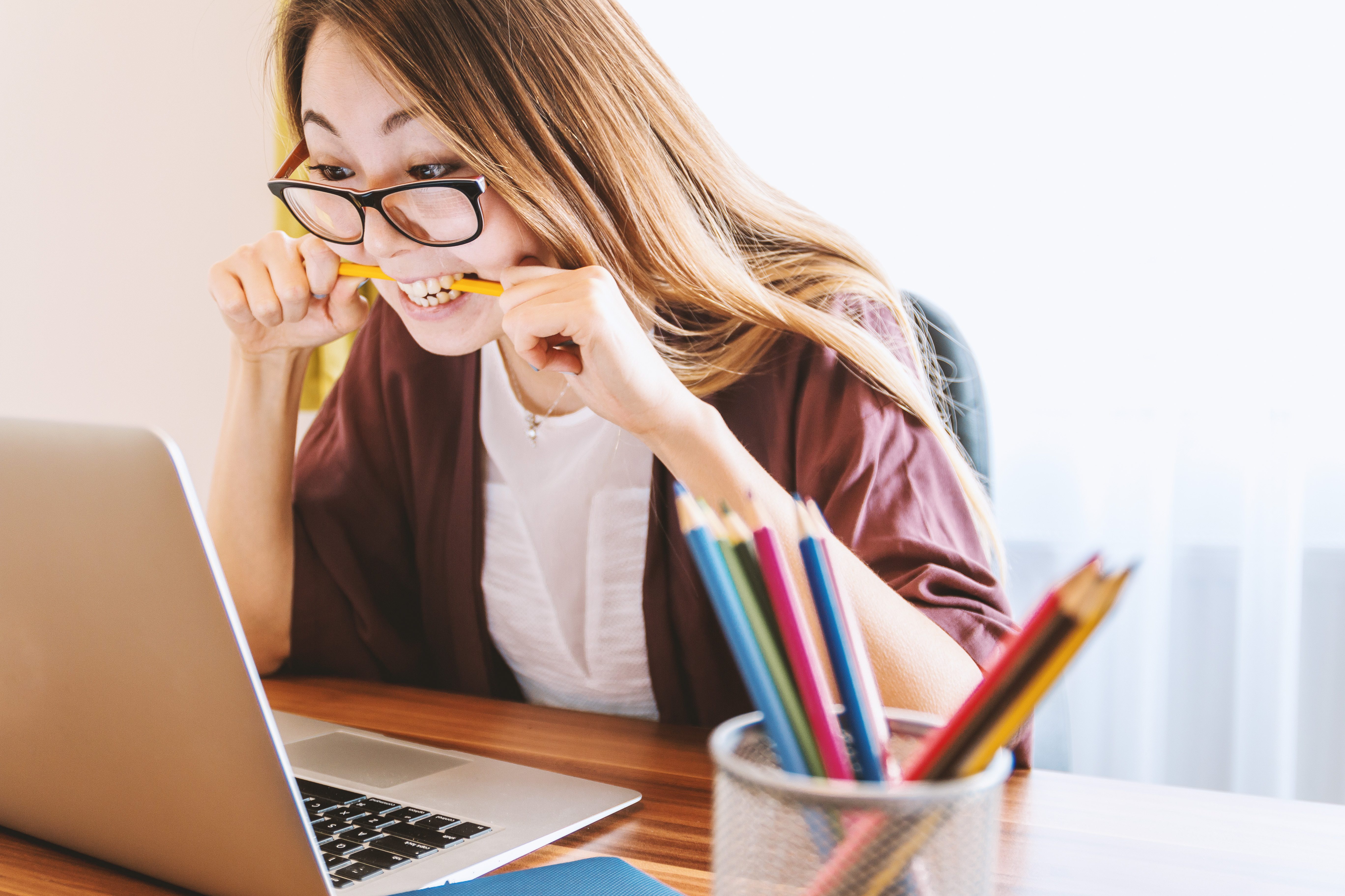 Girl biting pencil in stress