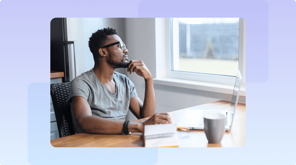 person sitting at desk looking out of window
