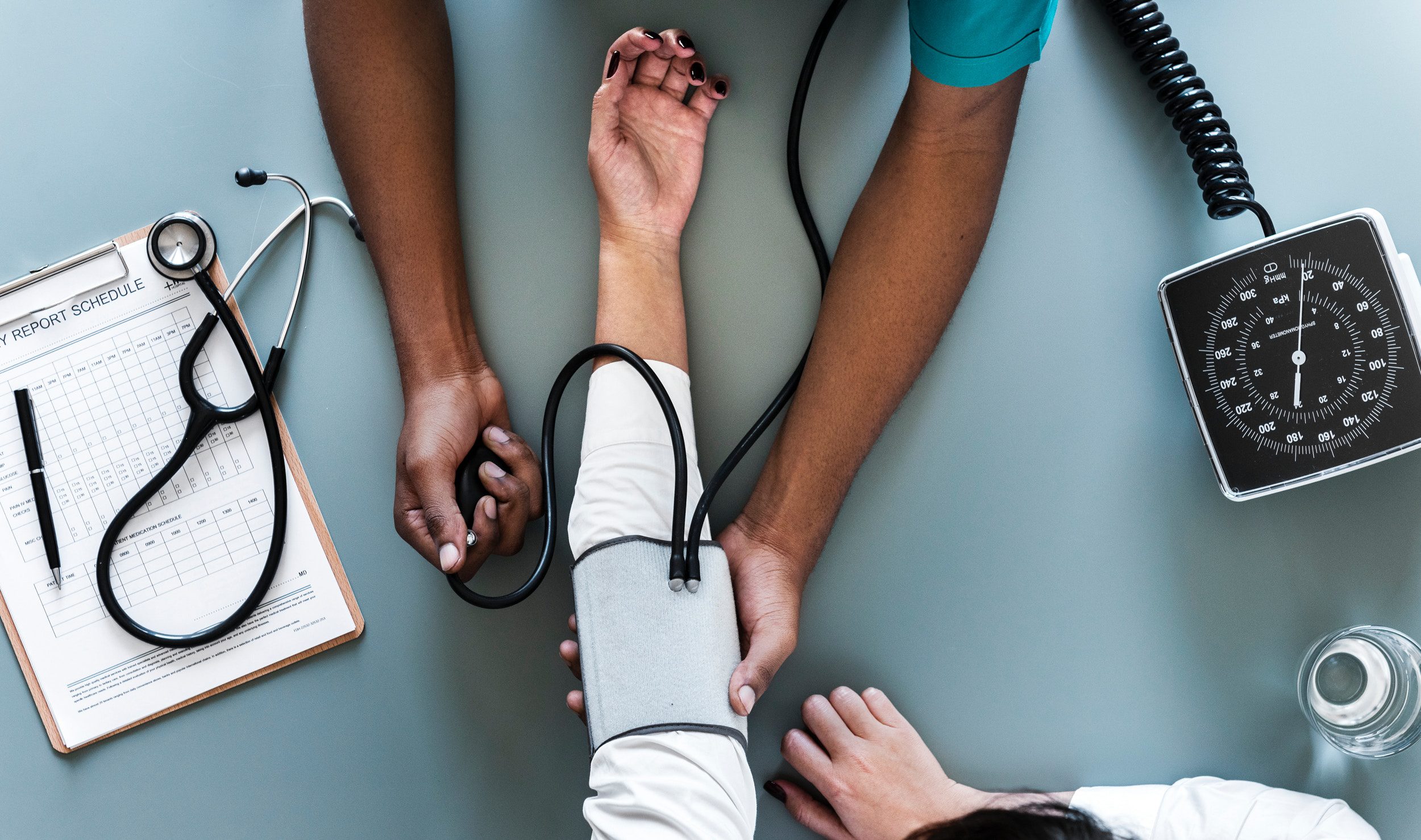 Doctor checking patients blood pressure